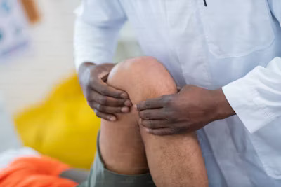 a nurse attending to a patent's knee injury